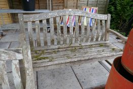 A solid large wooden garden bench