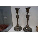 A pair of antique silver plated on copper candlesticks of Classical style