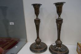 A pair of antique silver plated on copper candlesticks of Classical style