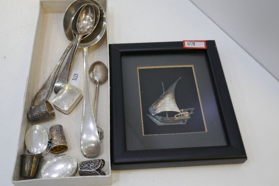 A lot comprising silver items to include a large dessert spoon, thimbles, very pretty decorative