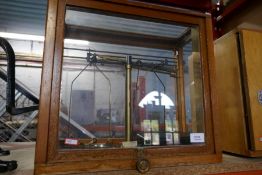 Cased medical scales with weights and a cased wooden microscope