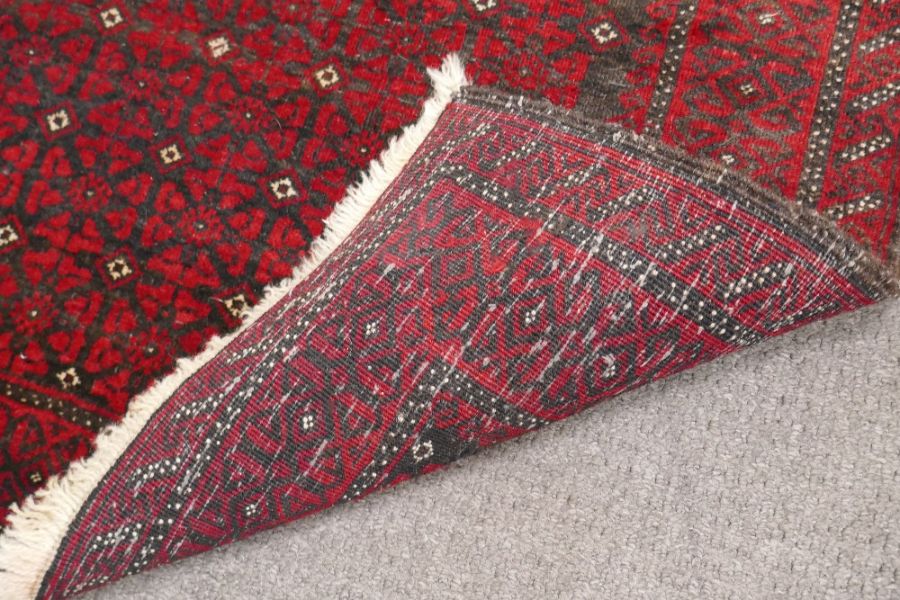 An Afghan red rug having repeated design, 172cm - Image 2 of 2