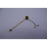 Pretty unmarked yellow metal stick pin with flower head detail with a diamond in the centre, with sa