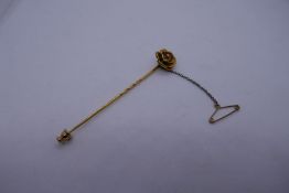 Pretty unmarked yellow metal stick pin with flower head detail with a diamond in the centre, with sa