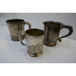Three silver cups, one decorated with engraved and embossed design and a central cartouche, Sterling