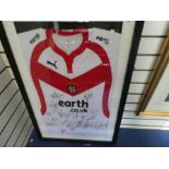 A St Helens rugby shirt bearing signatures, presumably of the team, framed and glazed