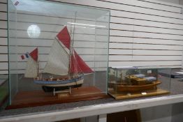 A wooden fishing boat in glazed case and one other of Thames Steam Cruiser, the largest 68.5cm