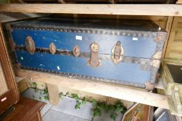 A large blue iron band trunk