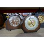 Three wooden mantle clocks and two black slate mantle clocks, one with a plaque