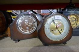 Three wooden mantle clocks and two black slate mantle clocks, one with a plaque