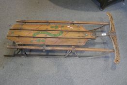 A vintage 'Lightning Guider' steerable sledge on metal runners, 105cms