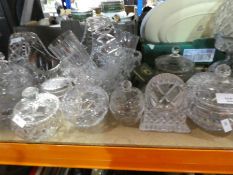 A large quantity of cut crystal items to include pots with lids, bowls, lamp, baskets, glasses, etc