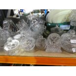 A large quantity of cut crystal items to include pots with lids, bowls, lamp, baskets, glasses, etc