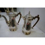 A matching silver hot water pot and coffee pot, large, heavy, of nice quality and design. Decorative