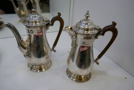 A matching silver hot water pot and coffee pot, large, heavy, of nice quality and design. Decorative