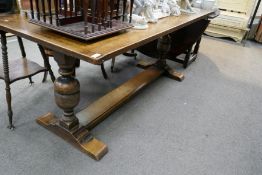 A reproduction oak refectory table on melon bulb supports, 183cms