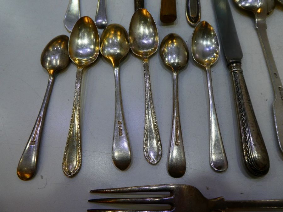 A lot comprising silver and white metal cutlery. To include a Georgian heavy silver spoon, London 18 - Image 2 of 10