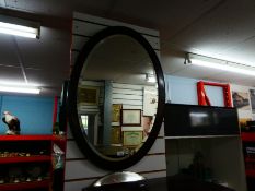 Two vintage bevel edged mirrors, one being oval and framed