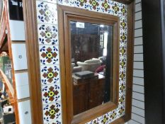 Tiled framed wooden wall mirror and another bevelled mirror