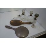 A silver dressing table set comprising a silver backed brush, silver backed hand mirror, two silver