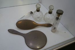 A silver dressing table set comprising a silver backed brush, silver backed hand mirror, two silver