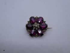 Silver gilt brooch with in the form of a flower head set almandine garnets and seed pearls, marked 8