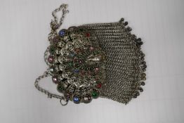 Middle Eastern white metal clutch bag with peacock decoration and a tribal necklace