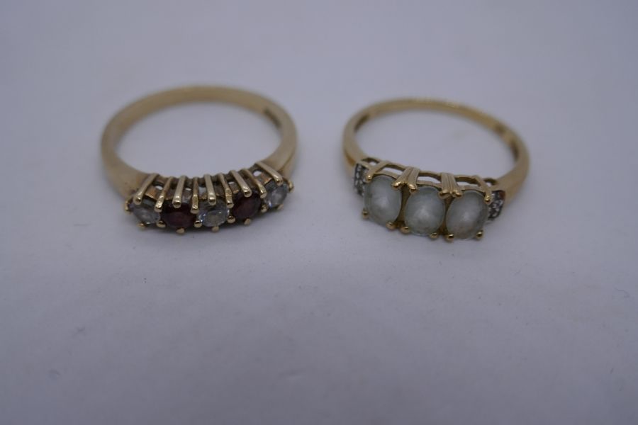 2 9ct yellow gold dress rings, one set with garnets and clear stones the other 2 oval white stones, - Image 3 of 3