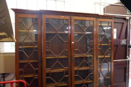 A Victorian mahogany break front bookcase having Astragal doors above lower drawers, 222cm across