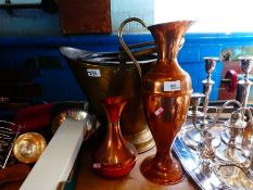 A brass coal scuttle and two copper jugs