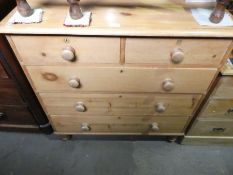 Stripped pine chest of 2 short over 3 long drawers on bun supports