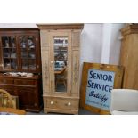 An old pine single wardrobe having decoration of flowers with drawer below, 90cm wide