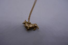 9ct yellow gold fine rope twist fine neckchain hung with 9ct yellow gold Corgi pendant marked 375, 6