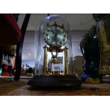 Vintage glass carriage clock under a glass dome