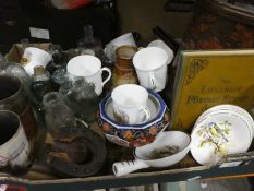 A box with glass bottles, china mugs and plates, treen items and books to include Black Beauty