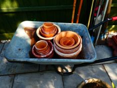 Wheelbarrow and terracotta pots