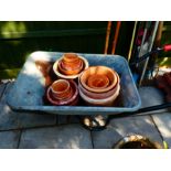 Wheelbarrow and terracotta pots