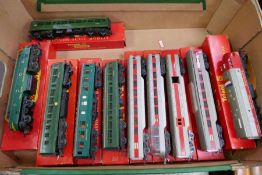 A quantity of boxed Tri-ang OO gauge locomotives and coaches to include double ended electric loco a