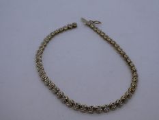 9ct yellow gold tennis bracelet, set with clear, possibly diamond chips, marked 375 on clasp, approx