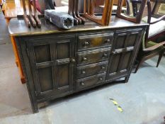 Vintage dark ercol sideboard with 4 central drawers flanked cupboards