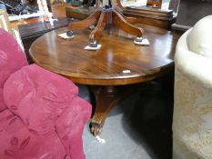 Antique circular mahogany tilt-top dining table on trif-form base