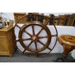 An old large ships wheel having brass inlay, 115cm