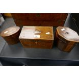 An oval inlaid antique tea caddy and two others