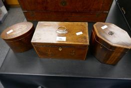 An oval inlaid antique tea caddy and two others