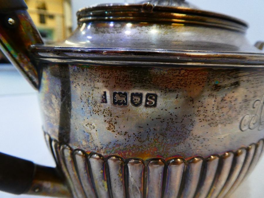 An Edwardian silver teapot with gadrooned body and central engraved initials AA. Hallmarked London 1 - Image 5 of 6