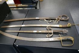 A Victorian sword having curved blade, another curved sword with steel scabbard and two others (4)