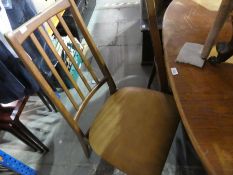 Mid century teak oval extending dining table and set of 4 1970s bar back dining chairs with faux tan