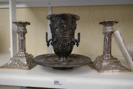 An antique plated on copper vase and stand having pierced decoration, and a pair of candlesticks