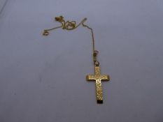 9ct yellow gold fine neckchain hung with a 9ct yellow gold cross with engraved detail, both marked,