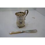 A very high quality and decorative Victorian cup with engraved floreated and fruit design, on four p
